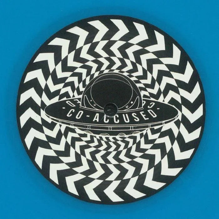 Vinyl record with black and white zigzag pattern, UFO graphic, and Co-Accused text at center.