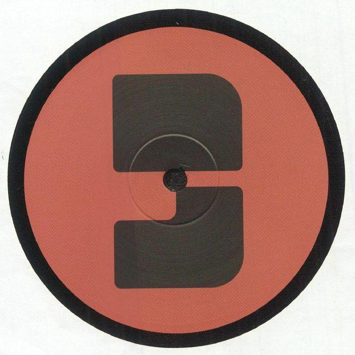 Vinyl record with red label and black geometric design, close-up center view