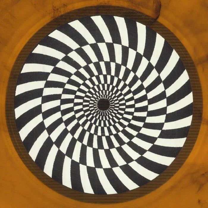 Black and white vinyl record with hypnotic spiral pattern on a brown background