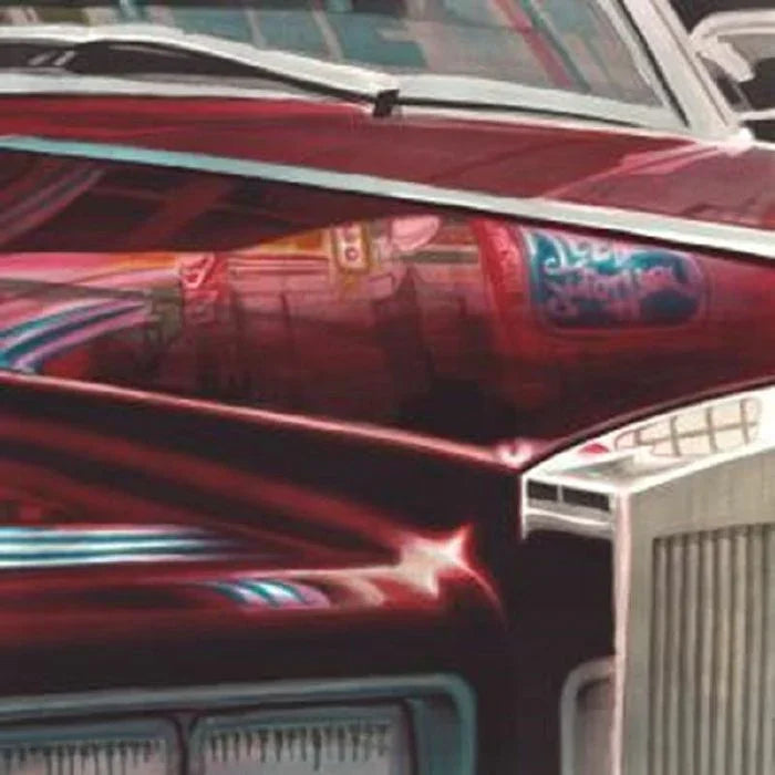 Close-up of vintage classic car hood with chrome detail and street reflections
