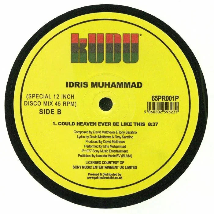 Close-up of Idris Muhammad vinyl record label, Kudu Records, yellow with black text, disco single.