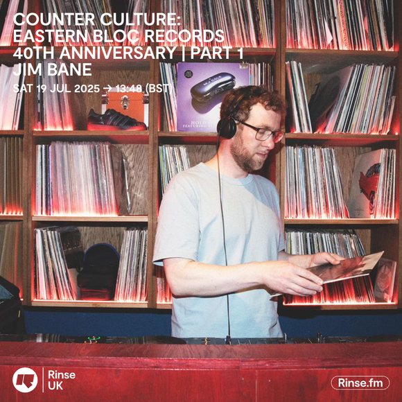 DJ Jim Bane wearing headphones selecting vinyl records in a retro-style record room for Eastern Bloc Records 40th anniversary