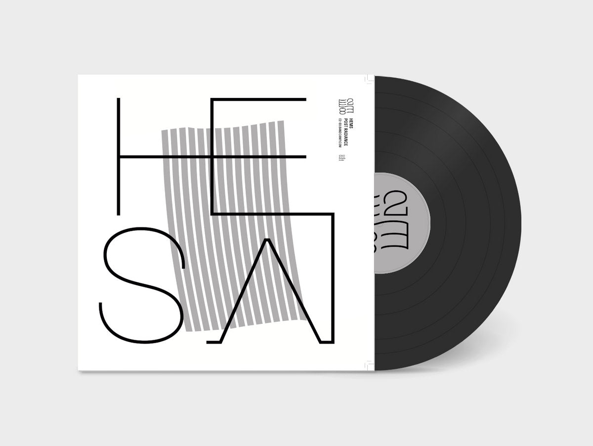 Black vinyl record partially out of white sleeve with abstract black and gray geometric design