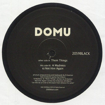 DOMU vinyl record label with tracklist including Them Things, A Madness, Not Him Again