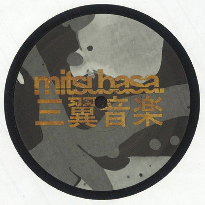 Close-up of Mitsuhasa record label with gold lettering and abstract black and gray background
