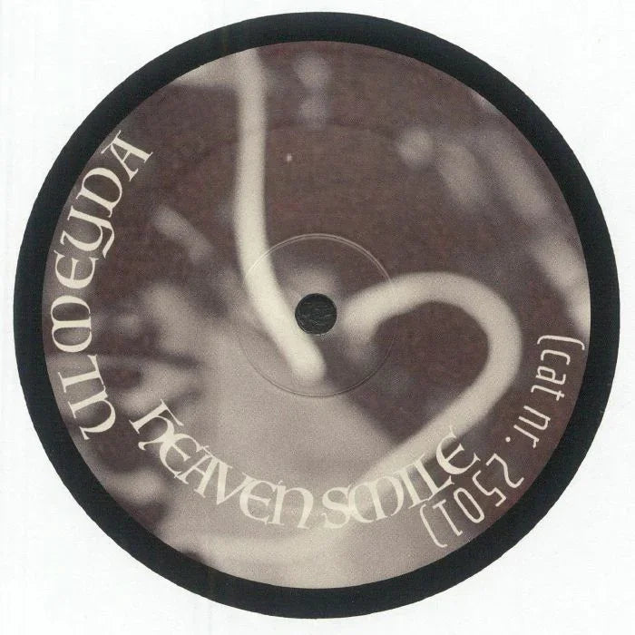 Vinyl record with abstract heart design and 'Heaven Smile' text on label.