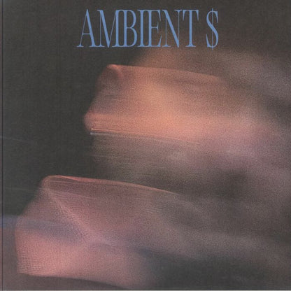 Abstract blurry image with dark background and soft purple-pink hues featuring text 'AMBIENT $'