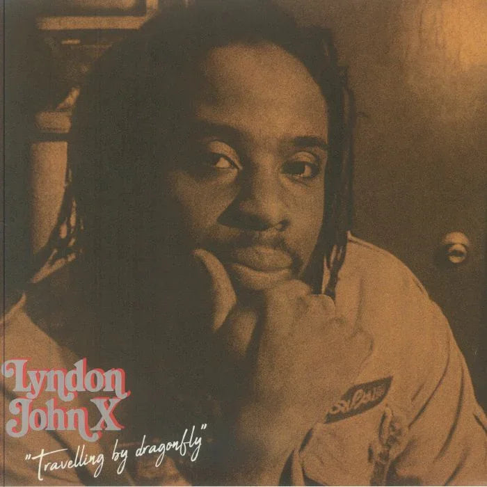Sepia-toned album cover featuring a thoughtful man with dreadlocks, text reads 'Lyndon John X Travelling by dragonfly'.