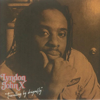 Sepia-toned album cover featuring a thoughtful man with dreadlocks, text reads 'Lyndon John X Travelling by dragonfly'.