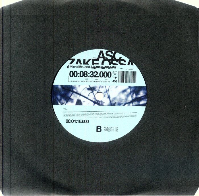 Vinyl record with a label featuring tree imagery and text on a black background