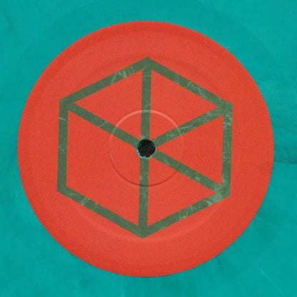 Teal and red vinyl record with geometric cube pattern on the label