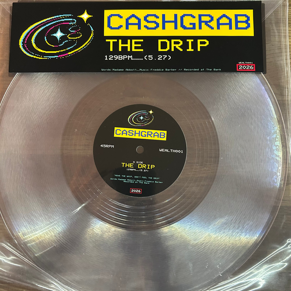 A Cashgrab vinyl record in a clear plastic sleeve, featuring a silver mirrored disc with a black center label and a black header card reading 'CASHGRAB THE DRIP' on a wood surface.