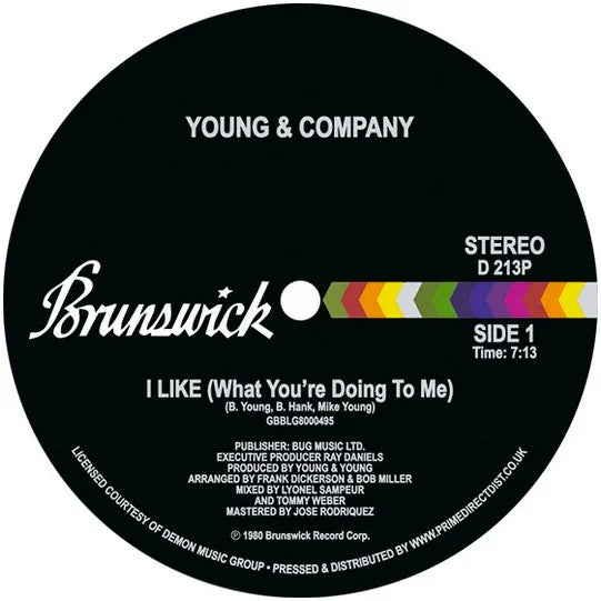 Brunswick vinyl record label for Young & Company single 'I Like (What You’re Doing To Me)', Side 1, black background with colorful stripe, stereo, 7:13 duration.