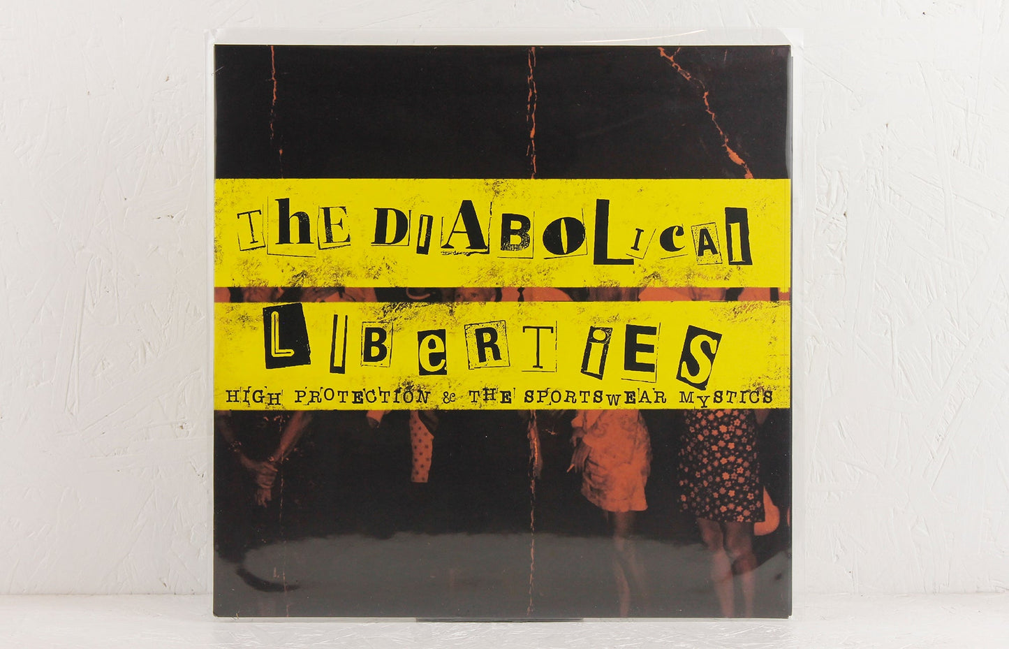 The Diabolical Liberties vinyl album cover with yellow ransom note style text and vintage band photo