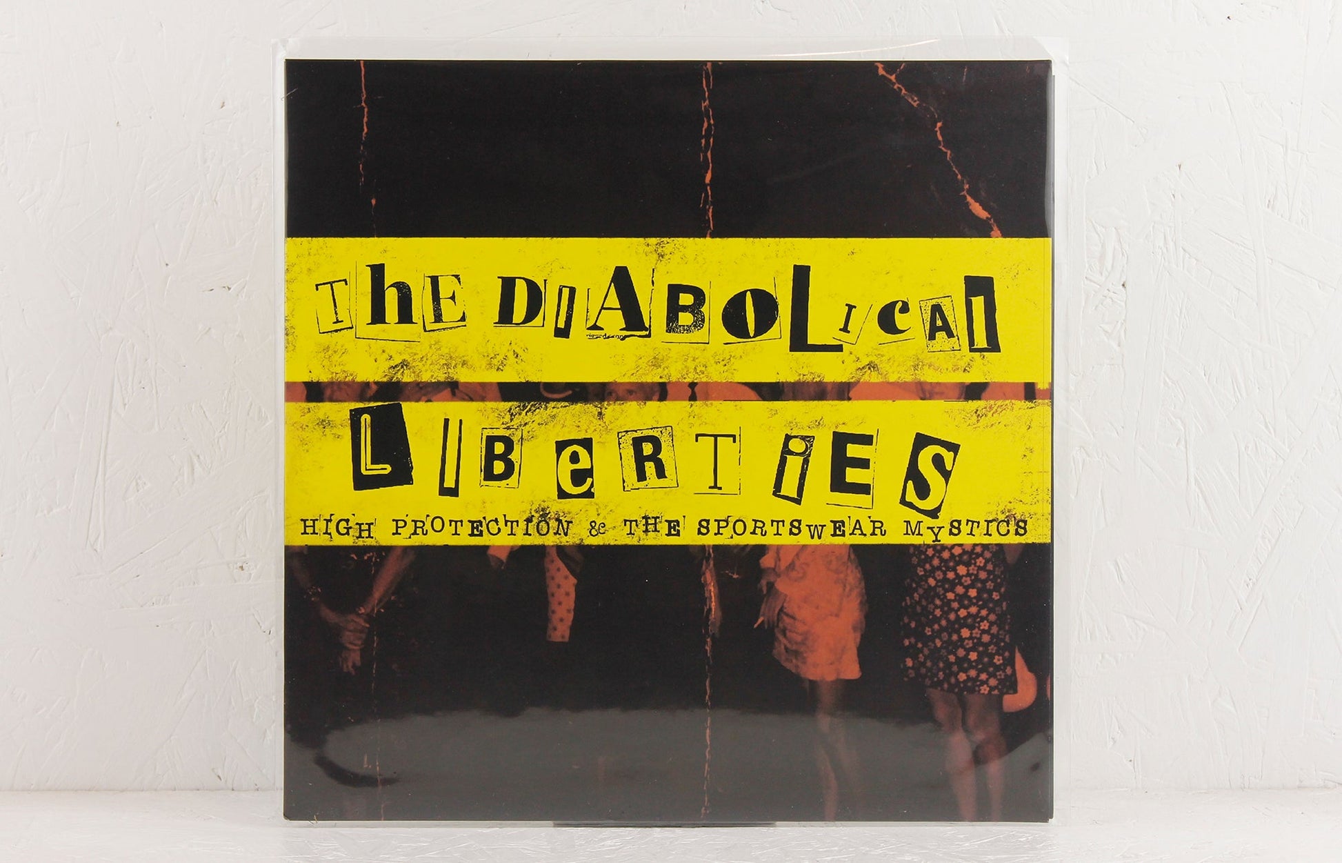 The Diabolical Liberties vinyl album cover with yellow ransom note style text and vintage band photo